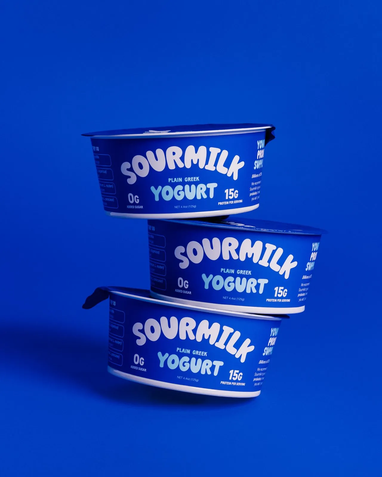 A stack of Sourmilk cups on blue